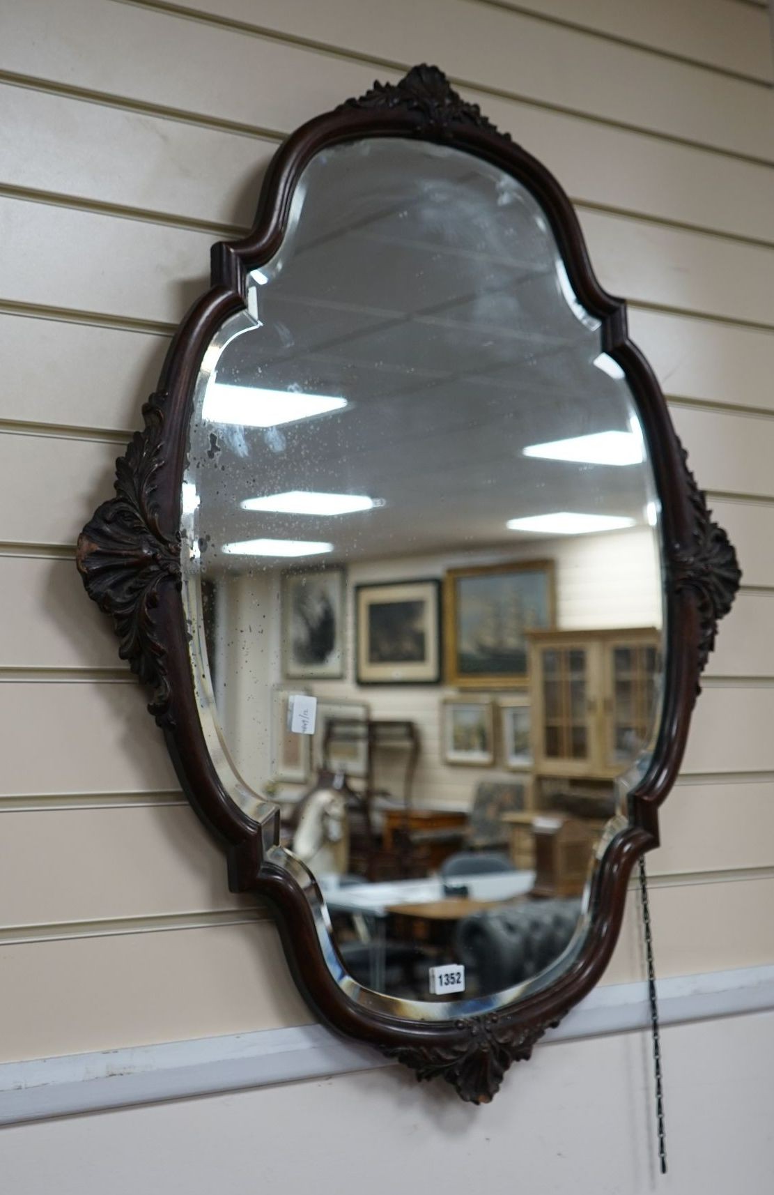 An early 20th century mahogany oval wall mirror, width 74cm, height 94cm